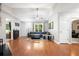 Open living room boasts hardwood floors, a ceiling fan, and a large window for natural light at 121 Danielle Ct, Villa Rica, GA 30180