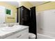 Bathroom with a white marbled sink top, black cabinet, black shower curtain and white tiles at 1741 Branch View Dr, Marietta, GA 30062