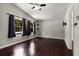 Spacious bedroom with dark wood-look floors, three windows, and a ceiling fan at 1741 Branch View Dr, Marietta, GA 30062