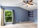 Spacious carpeted bedroom featuring a ceiling fan and a large window with green outdoor views at 1741 Branch View Dr, Marietta, GA 30062