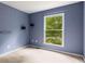 Bedroom with a window that allows natural light to illuminate the blue walls and carpeted floor at 1741 Branch View Dr, Marietta, GA 30062
