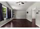 Bedroom featuring dark wood-look floors, three windows, a ceiling fan, and neutral-colored walls at 1741 Branch View Dr, Marietta, GA 30062