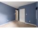 Bedroom with beige carpet, blue walls, and a closet with white folding doors at 1741 Branch View Dr, Marietta, GA 30062