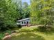 View of home with gray siding through trees and a green yard at 1741 Branch View Dr, Marietta, GA 30062