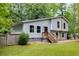 Charming split-level home with gray siding, stone accents, and a wooden porch, nestled in a lush green yard at 1741 Branch View Dr, Marietta, GA 30062