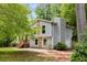 Two-story home featuring gray siding, stone accents, attached garage, and lush green surroundings at 1741 Branch View Dr, Marietta, GA 30062
