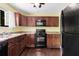 Kitchen with dark wood cabinets, stainless steel appliances, a window, and a ceiling fan at 1741 Branch View Dr, Marietta, GA 30062