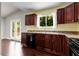 Kitchen area with tile countertops, dark wood cabinets, stainless steel appliances, and a sink at 1741 Branch View Dr, Marietta, GA 30062