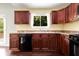 Kitchen with dark cabinets, black appliances, tile countertops, and a view to the backyard deck at 1741 Branch View Dr, Marietta, GA 30062