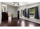 Bright living room with dark hardwood floors, large windows, and staircase leading to the second floor at 1741 Branch View Dr, Marietta, GA 30062