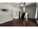 Open living room with hardwood floors, ceiling fan, and access to kitchen and staircase at 1741 Branch View Dr, Marietta, GA 30062