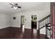 Spacious living room with hardwood floors, ceiling fan, and access to kitchen and staircase at 1741 Branch View Dr, Marietta, GA 30062