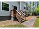 Wooden porch with stone accents with gray siding, inviting entrance and well-maintained walkway at 1741 Branch View Dr, Marietta, GA 30062