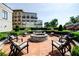 Outdoor fire pit with seating surrounded by lush landscaping offering a serene community space at 2233 Peachtree Ne Rd # 903, Atlanta, GA 30309