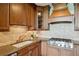 Close-up of kitchen with custom cabinets, granite countertops, and stainless steel range at 2233 Peachtree Ne Rd # 903, Atlanta, GA 30309