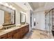 Luxurious bathroom featuring dual sinks, granite countertops, and a glass-enclosed shower at 2233 Peachtree Ne Rd # 903, Atlanta, GA 30309