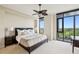 Spacious main bedroom with plush carpeting, ceiling fan, and access to a private balcony at 2233 Peachtree Ne Rd # 903, Atlanta, GA 30309