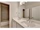 Bathroom features a double sink vanity, large mirror and tile shower at 240 Walker Avenue, Roswell, GA 30076