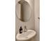Bathroom featuring a sleek sink with modern faucet and round mirror at 240 Walker Avenue, Roswell, GA 30076