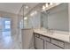 Bathroom featuring sleek vanity with modern fixtures, quartz countertop, and glass shower stall at 240 Walker Avenue, Roswell, GA 30076