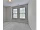 Bedroom featuring neutral tones, carpet, and lots of natural light from multiple windows at 240 Walker Avenue, Roswell, GA 30076