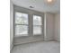 Bedroom features two windows with blinds, neutral walls and carpet at 240 Walker Avenue, Roswell, GA 30076