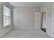 Bedroom with plush carpet, window with blinds, and an open door at 240 Walker Avenue, Roswell, GA 30076