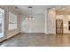 Dining area featuring hardwood floors and views of the kitchen with stainless steel refrigerator at 240 Walker Avenue, Roswell, GA 30076