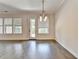 Open dining area with hardwood floors, large windows, and modern light fixture at 240 Walker Avenue, Roswell, GA 30076