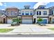 View of three townhouses showcasing individual design and a shared driveway at 240 Walker Avenue, Roswell, GA 30076