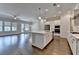 Open kitchen and living area with pendant lighting, large island, and stainless appliances at 240 Walker Avenue, Roswell, GA 30076
