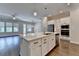 Open kitchen and living area with pendant lighting, large island, and stainless appliances at 240 Walker Avenue, Roswell, GA 30076