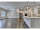 Modern kitchen with stainless steel appliances, island with sink, and hardwood floors, seamlessly blending style and function at 240 Walker Avenue, Roswell, GA 30076