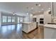 Open kitchen and living area with pendant lighting, large island, and stainless appliances at 240 Walker Avenue, Roswell, GA 30076