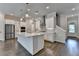 Open kitchen with stainless steel appliances, island, and cooktop, complemented by hardwood flooring for style and functionality at 240 Walker Avenue, Roswell, GA 30076