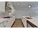 Modern kitchen showcasing white cabinets, stainless steel range hood, gas cooktop, and hardwood floors at 240 Walker Avenue, Roswell, GA 30076