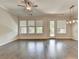 Bright living room featuring hardwood floors, multiple windows, and a stylish ceiling light for comfortable living at 240 Walker Avenue, Roswell, GA 30076