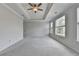 Spacious main bedroom featuring tray ceilings, carpet flooring, and natural light at 240 Walker Avenue, Roswell, GA 30076