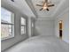 Spacious main bedroom featuring tray ceilings, carpet flooring, and large windows at 240 Walker Avenue, Roswell, GA 30076