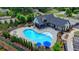Community kidney-shaped pool is surrounded by lounge chairs, umbrellas, and greenery near the community house at 240 Walker Avenue, Roswell, GA 30076