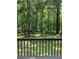 A view of a spacious backyard featuring a well-kept lawn as seen from the deck at 9278 Seminole Rd, Jonesboro, GA 30236
