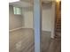 Finished basement with vinyl floors, closet, access to stairs, and modern lighting at 9278 Seminole Rd, Jonesboro, GA 30236