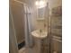 Bathroom featuring floral wallpaper, pedestal sink, and open shelving at 9278 Seminole Rd, Jonesboro, GA 30236