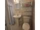 Bathroom featuring floral wallpaper, pedestal sink, and open shelving at 9278 Seminole Rd, Jonesboro, GA 30236