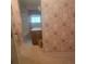Bathroom featuring floral wallpaper, tile floors, and a single sink vanity at 9278 Seminole Rd, Jonesboro, GA 30236
