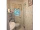Bathroom featuring floral wallpaper, pedestal sink, and open shelving at 9278 Seminole Rd, Jonesboro, GA 30236