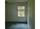 Bedroom featuring a window overlooking the outdoors and closet with folding doors at 9278 Seminole Rd, Jonesboro, GA 30236