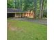 Charming home featuring brick accents, a covered carport, and mature trees enhancing its curb appeal at 9278 Seminole Rd, Jonesboro, GA 30236