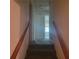 Carpeted hallway features wood railing, neutral walls, and leads to other rooms at 9278 Seminole Rd, Jonesboro, GA 30236