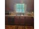 This kitchen features oak cabinets with granite countertops, stainless steel appliances, and a double sink at 9278 Seminole Rd, Jonesboro, GA 30236